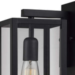 Single black wall sconce with glass shade