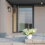 Single black wall sconce with glass shade