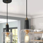 Mini bell pendant light with black finish and seeded glass