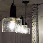 Mini bell pendant light with black finish and seeded glass